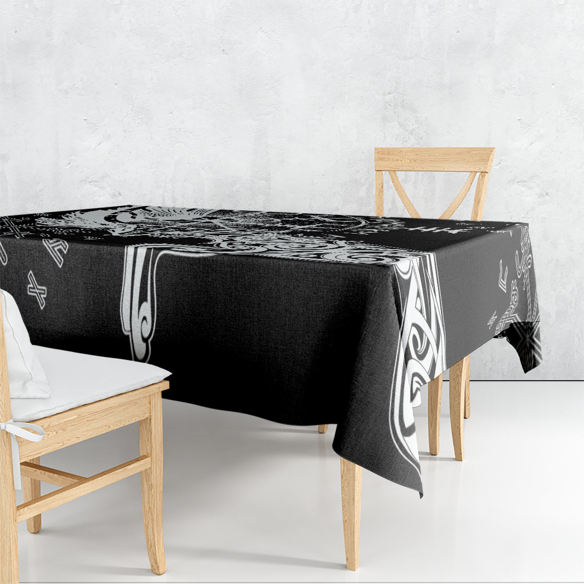 Black tablecloth with white Viking rune and raven patterns, draped over table