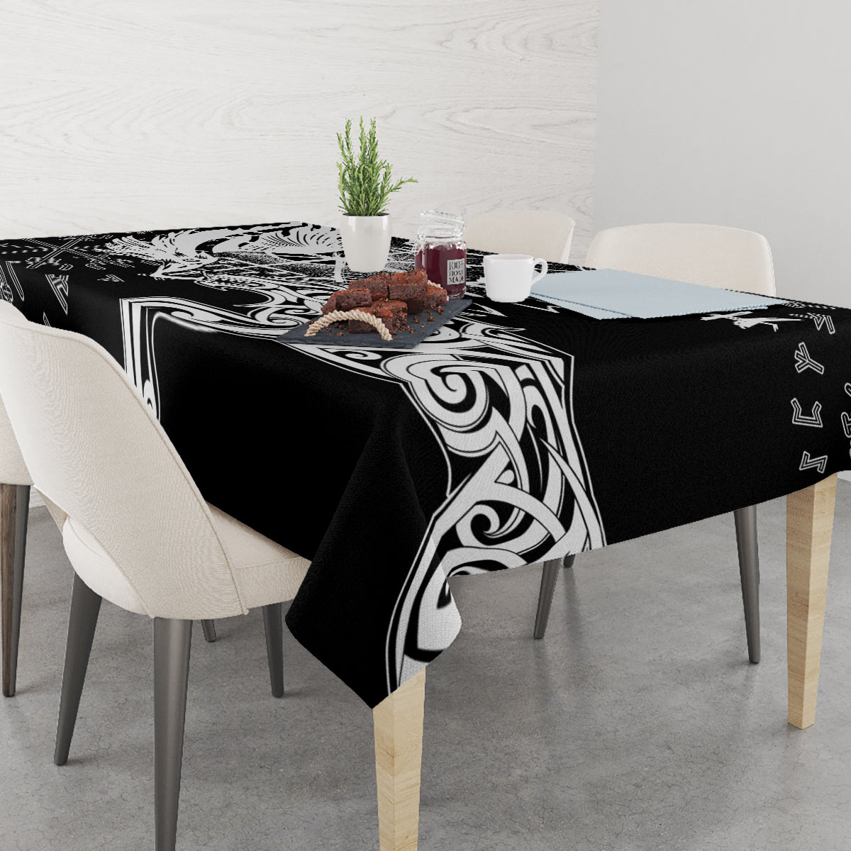 Black tablecloth with white Viking emblem and swirl graphics, draped to table edges