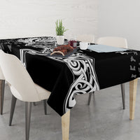 Black tablecloth with white Viking emblem and swirl graphics, draped to table edges