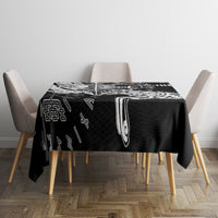Black tablecloth with white Viking rune sigil design, centered on a dining table