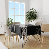 Black tablecloth with white Viking rune and raven motif, hanging neatly on table
