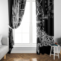 Black window curtain panels with white Viking raven and wolf artwork framing a doorway