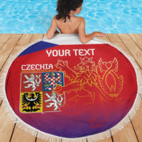 Round red Czech beach blanket with lion graphic and Czech crest, white fringe edge