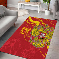 Red area rug with yellow crest and 'YOUR TEXT' lettering, framed by decorative border lines