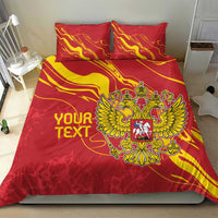 Red bedding set with gold flame lines and double-headed eagle crest across the duvet
