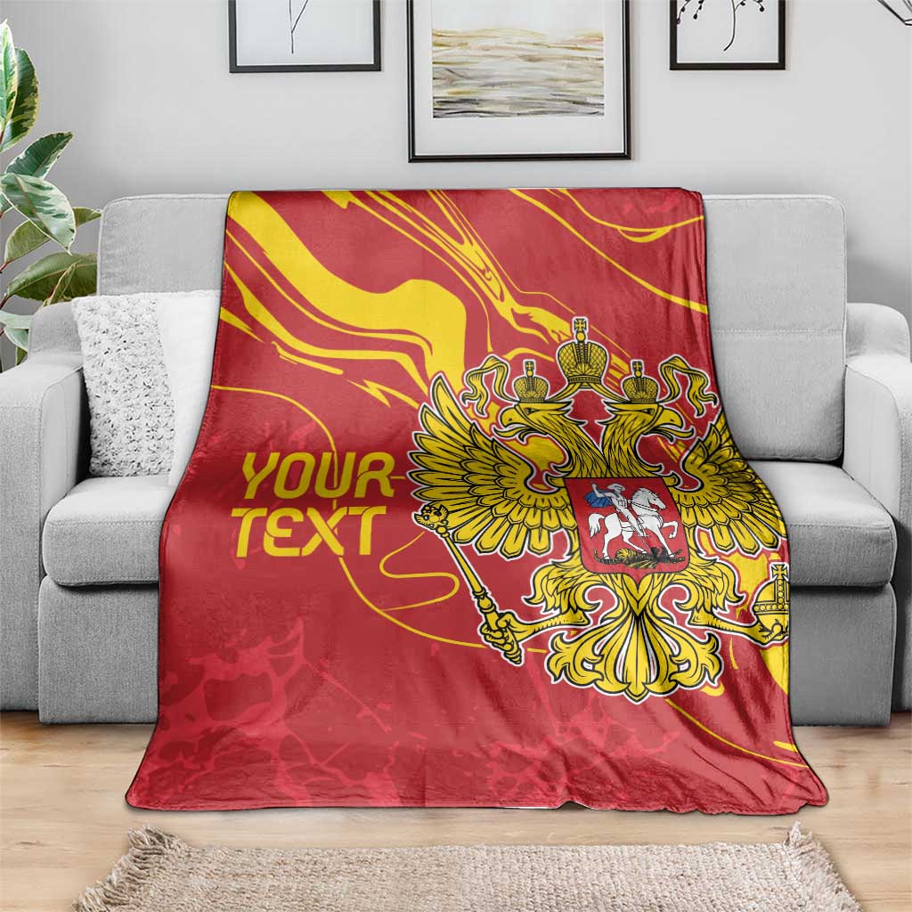 Red custom text blanket featuring gold double-headed eagle crest on a sofa throw