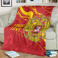 Red double-headed eagle blanket with gold emblem and custom text draped on armchair