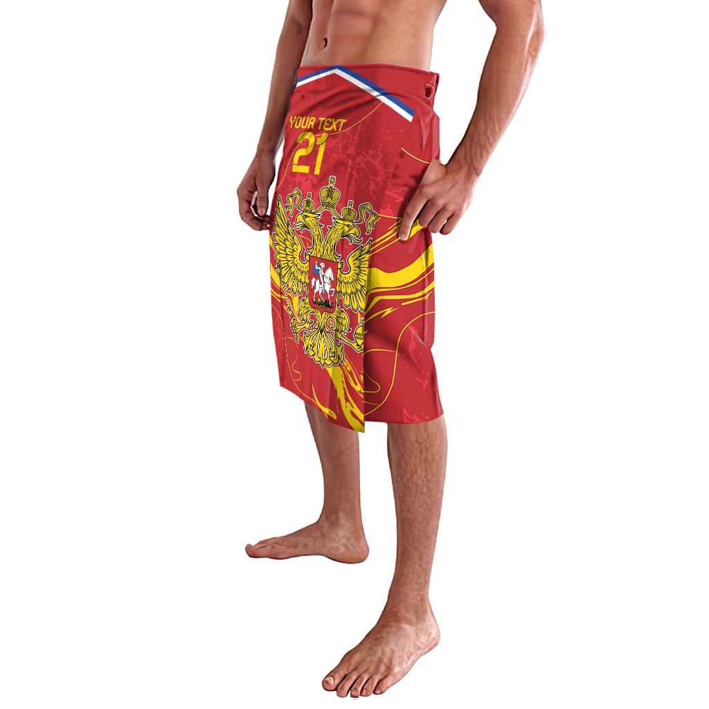 Red flag-print lavalava with yellow double-headed eagle crest and blue top trim
