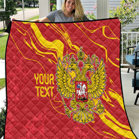 Red quilt with yellow swirls, double-headed eagle emblem, and personalized text