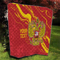 Red quilt with large double-headed eagle emblem in yellow and personalized text