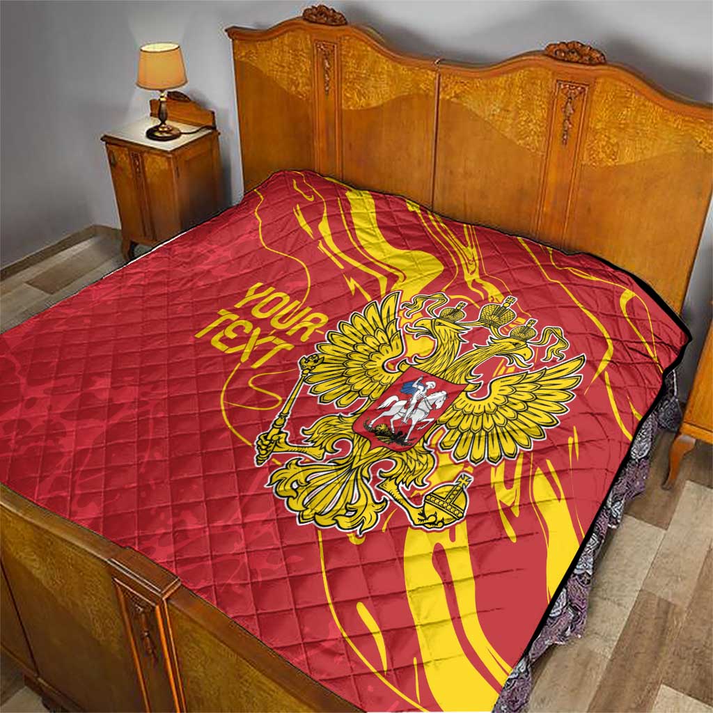 Red quilt with yellow double-headed eagle emblem, personalized text, on a bed