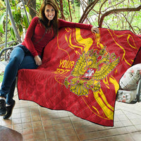 Red quilt with yellow swirls and double-headed eagle emblem, personalized text, spread out