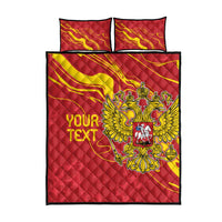 Red quilt bed set with double-headed eagle crest in yellow, flame-like swirl design, twin set view