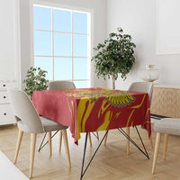 Red tablecloth on dining table with gold double-headed eagle design