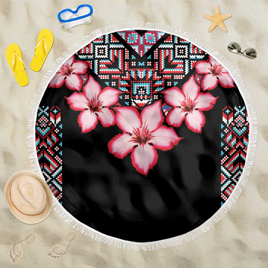 Round beach blanket in black with pink hibiscus, colorful tribal border, and white fringe