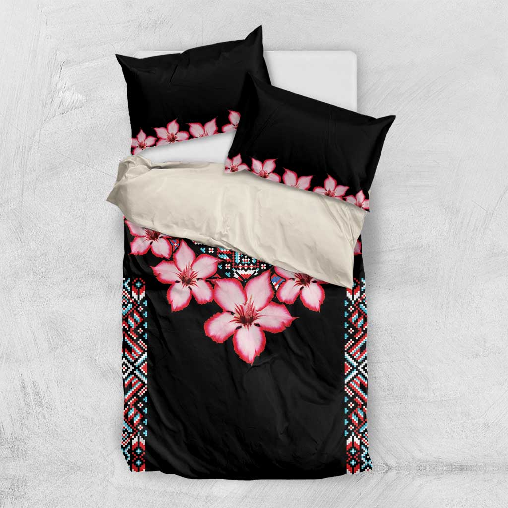 Black bedding set with pink hibiscus flowers, blue tribal border, on matching pillow shams