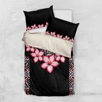 Black bedding set with pink hibiscus flowers, blue tribal border, on matching pillow shams