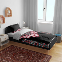 Black bedding set with pink hibiscus floral panel and blue tribal stripe detail