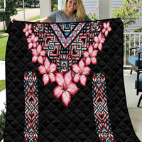 Black quilt blanket with pink flower centerpiece and multicolor tribal geometric trim