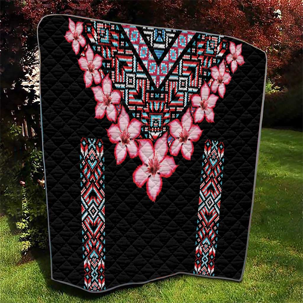 Black quilt blanket with pink flower motif and multicolor geometric V-shaped centerpiece