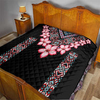 Black quilt blanket with pink floral print and patterned geometric border panels