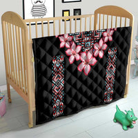Black quilt blanket for crib with pink flower centerpiece and colorful geometric side panels