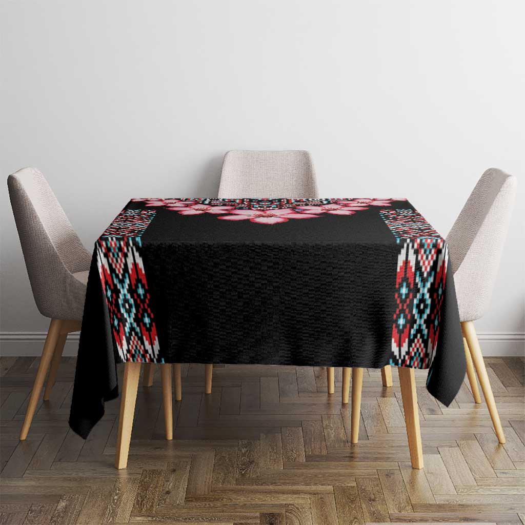 Black tablecloth with tribal border and red flower stripe on dining table
