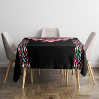 Black tablecloth with tribal border and red flower stripe on dining table
