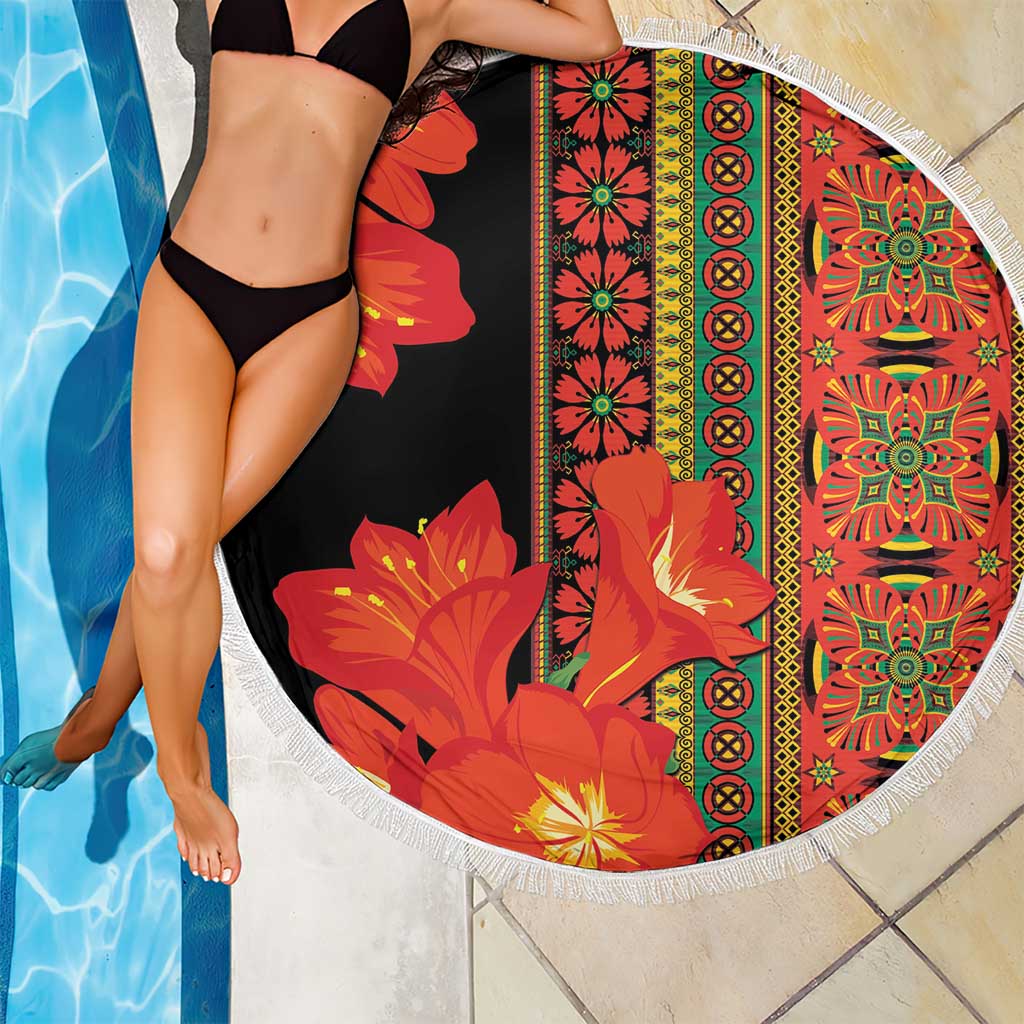 Round beach blanket, black base with red-orange floral print and white tassel fringe