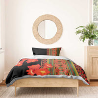 Black bedding set with orange-red flowers and multicolor stripe panel, shown on bed