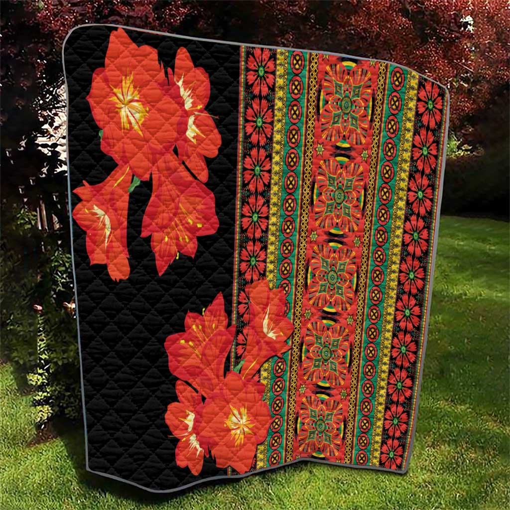 Quilt with black backing, red-orange blossoms, and central vertical multicolor decorative panel