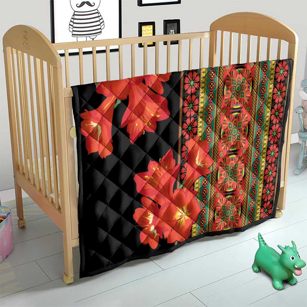 Black quilt for baby cot with red-orange floral print and vertical multicolor border panel