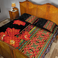 Black quilt bed set with red orange clivia blooms, green border, and two matching pillows
