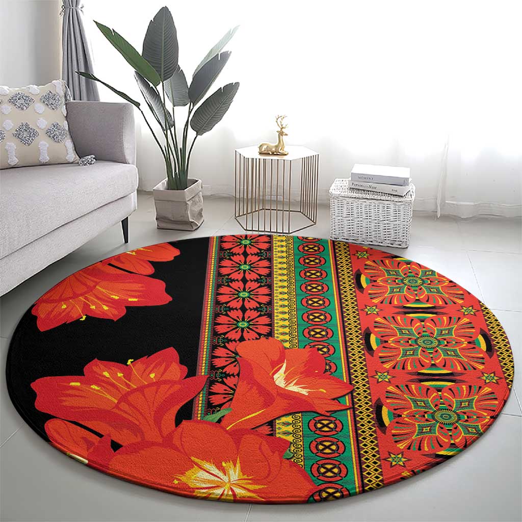 Round area rug with bold red-orange floral panels and central medallion border on black