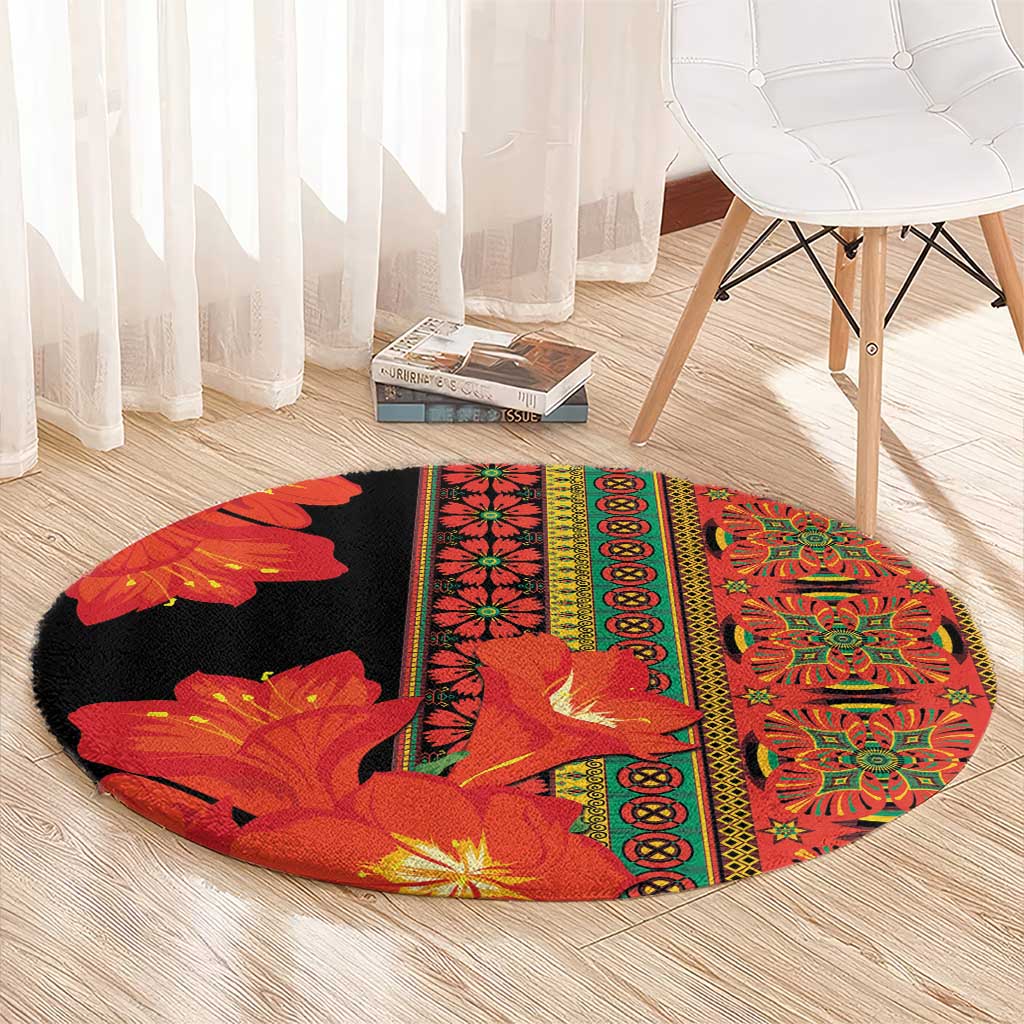 Round area rug in black and red-orange floral medallion design with yellow-green trim