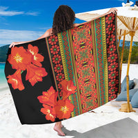 Black sarong with orange-red flower print and green geometric border stripes