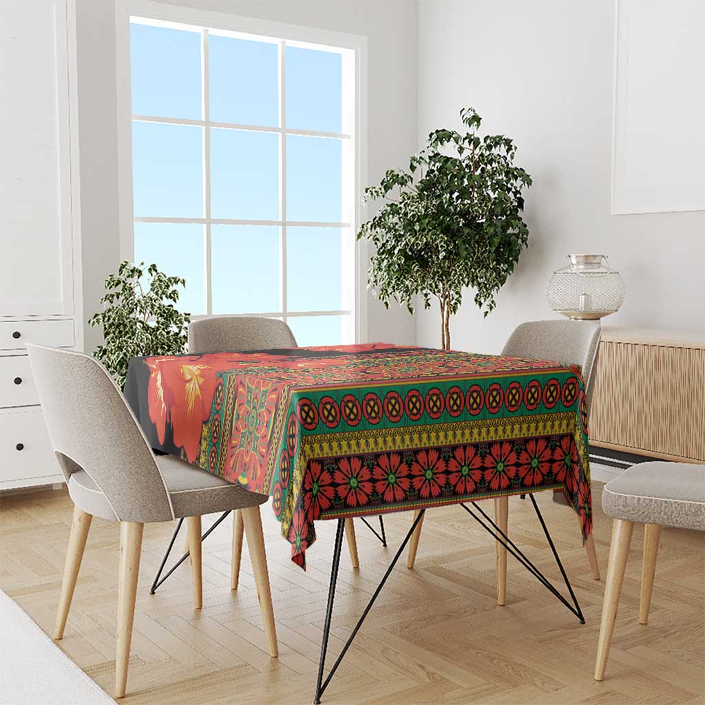 Printed tablecloth with red-orange clivia flowers, green trim, and black background