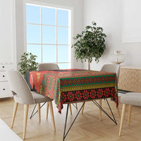 Printed tablecloth with red-orange clivia flowers, green trim, and black background