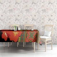 Black tablecloth with large clivia blooms and green-yellow geometric border