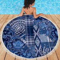 Round blue beach blanket with paisley and floral patchwork pattern, white fringe edge