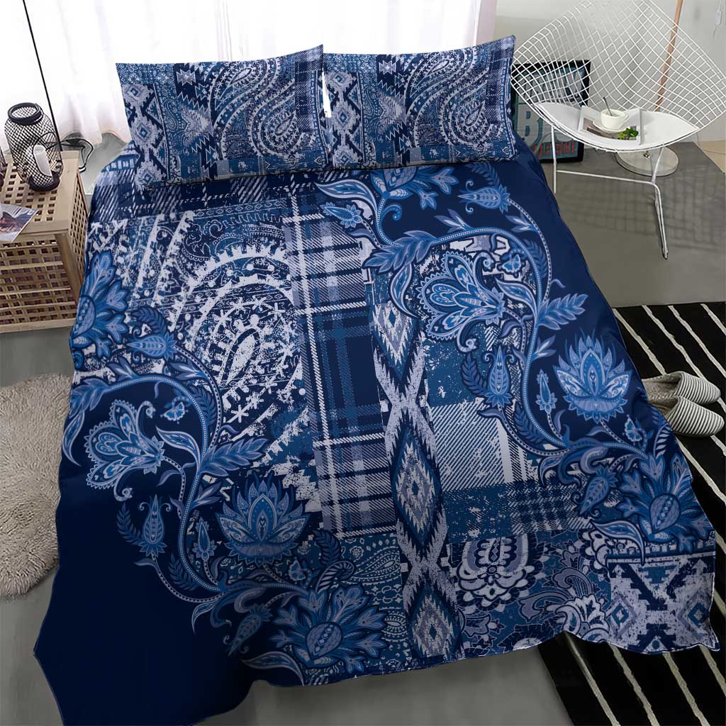 Blue patterned duvet with two pillow shams, paisley floral motif and plaid center panel