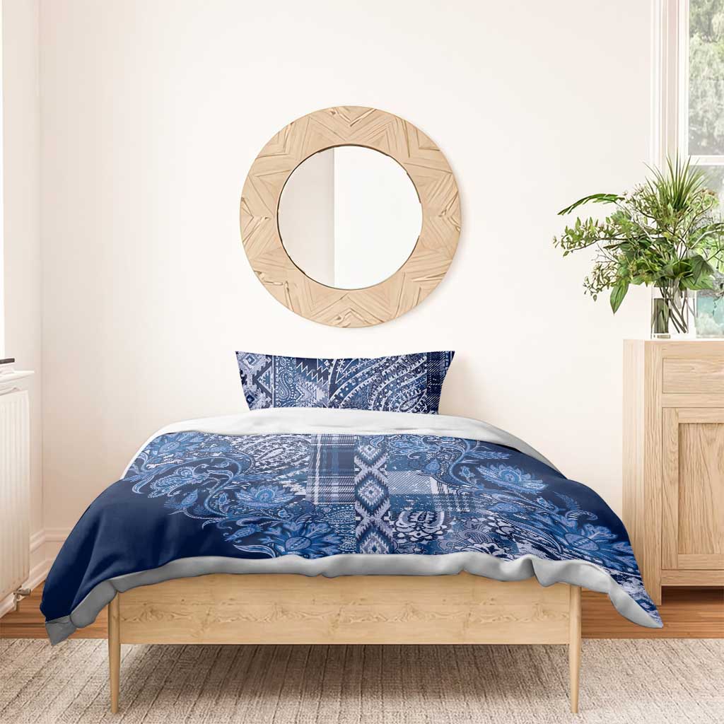 Blue patterned duvet cover and two shams with paisley floral design and plaid stripe