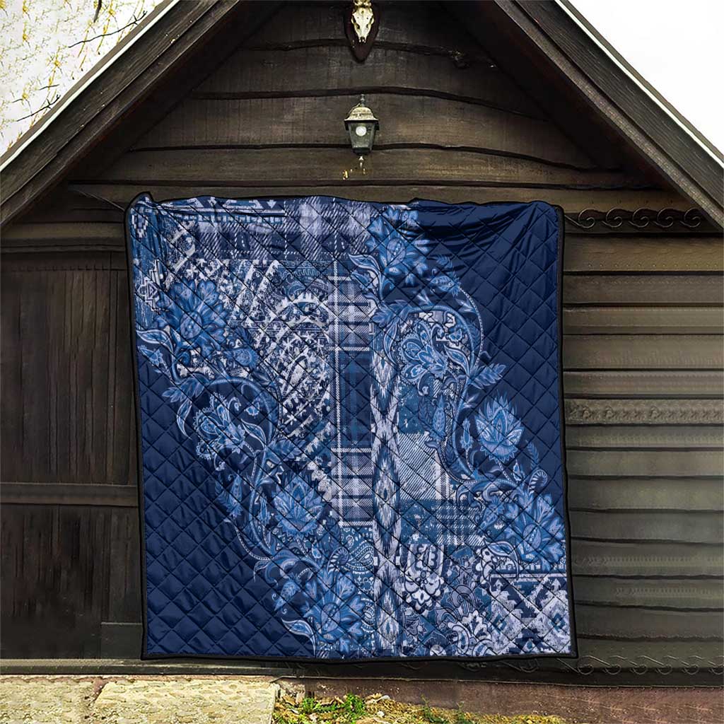 Blue quilt blanket with white paisley and plaid motif, diamond-quilted for outdoor display