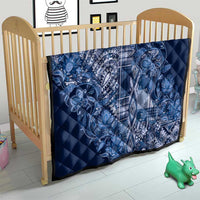 Blue diamond-quilted baby blanket with white paisley and plaid center panel
