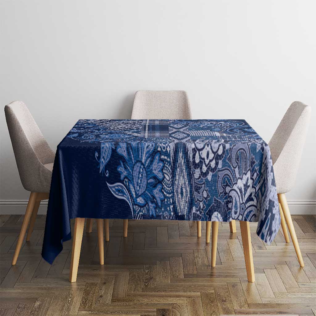 Blue paisley floral tablecloth neatly centered on square table, patterned border
