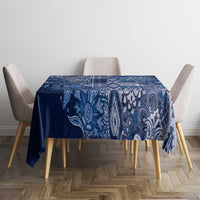 Blue paisley floral tablecloth neatly centered on square table, patterned border