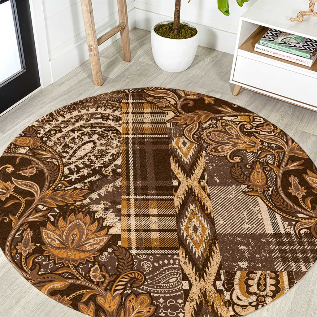 Round shuka-style carpet with paisley and plaid patchwork in gold, tan, and dark brown