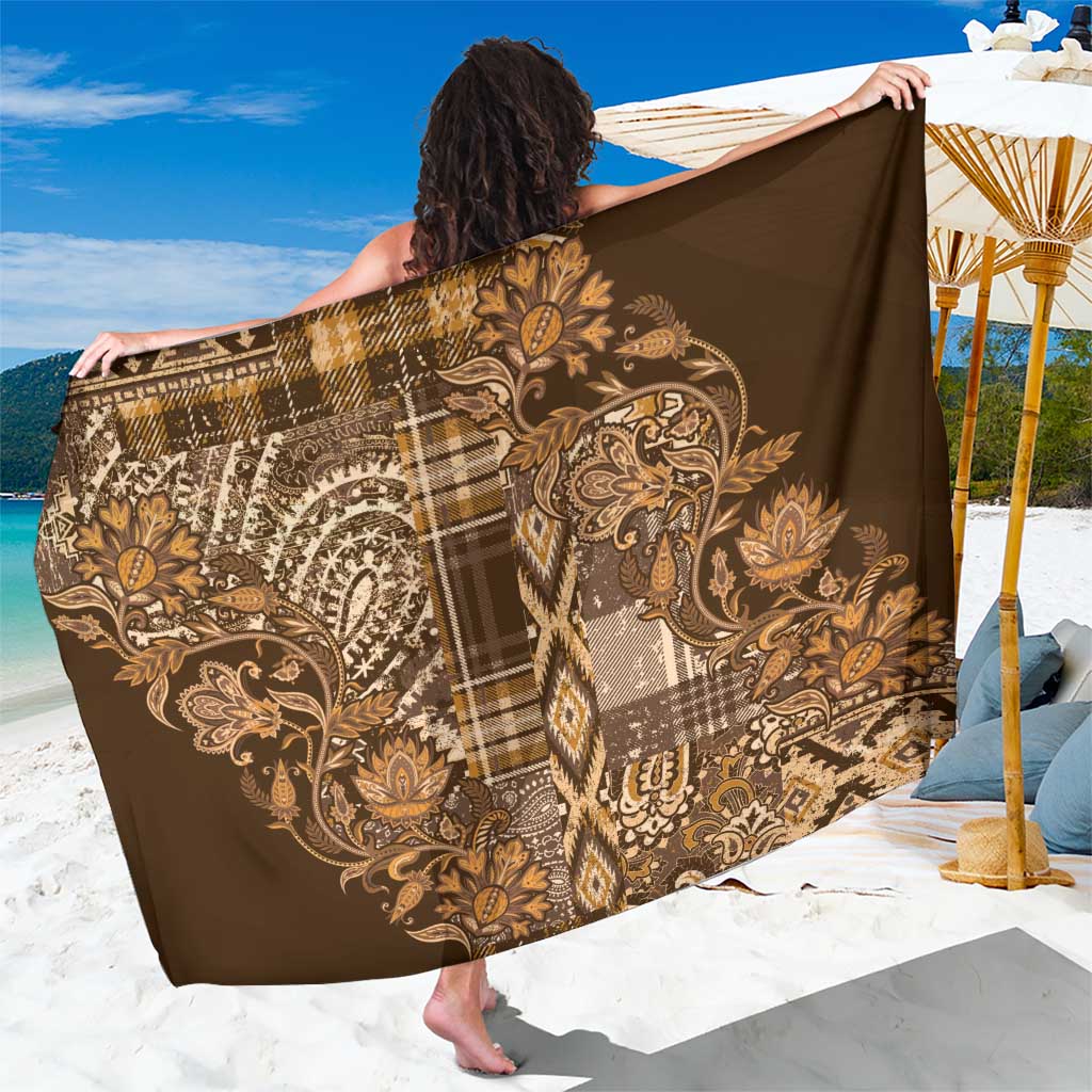 Gold and brown shuka sarong featuring paisley floral motifs and plaid blocks
