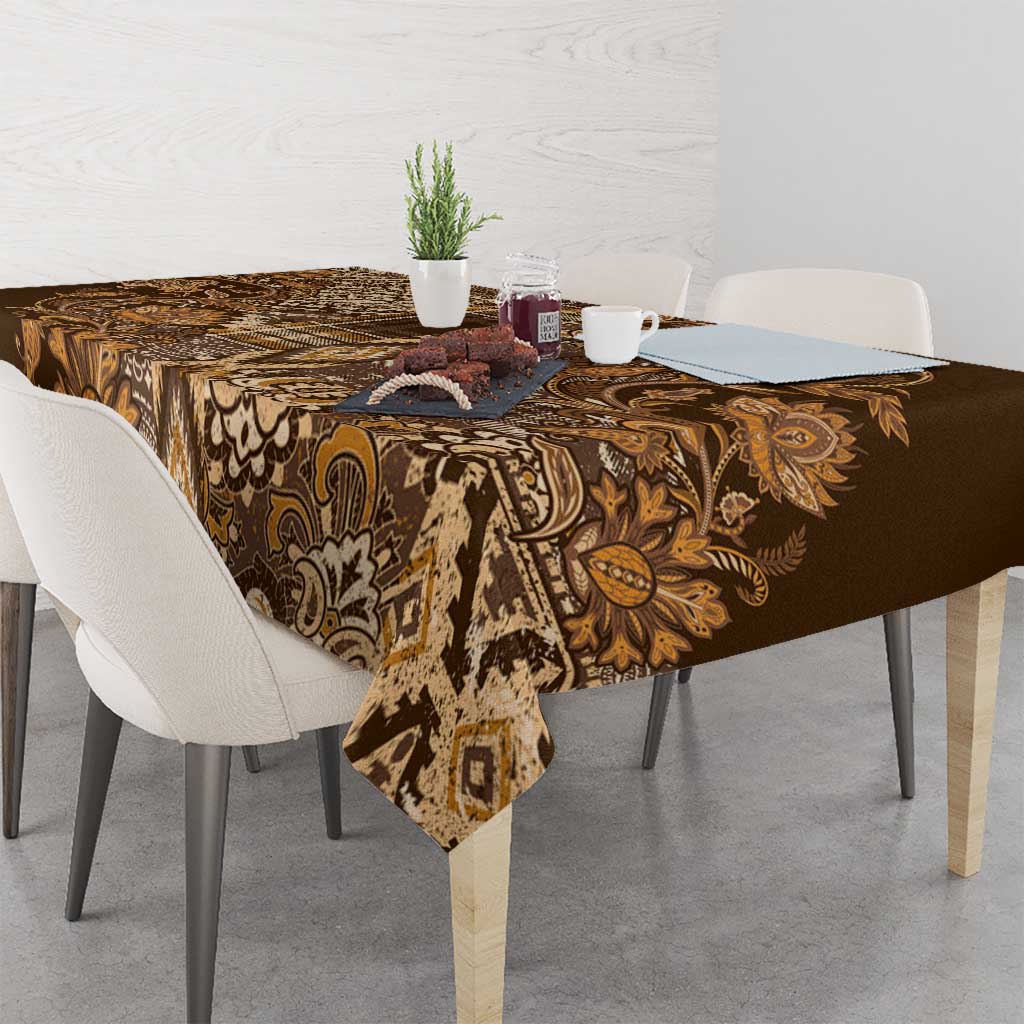 Gold and brown floral shuka tablecloth with leafy motifs on square dining table