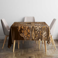 Gold and brown paisley shuka tablecloth on square table with four chairs